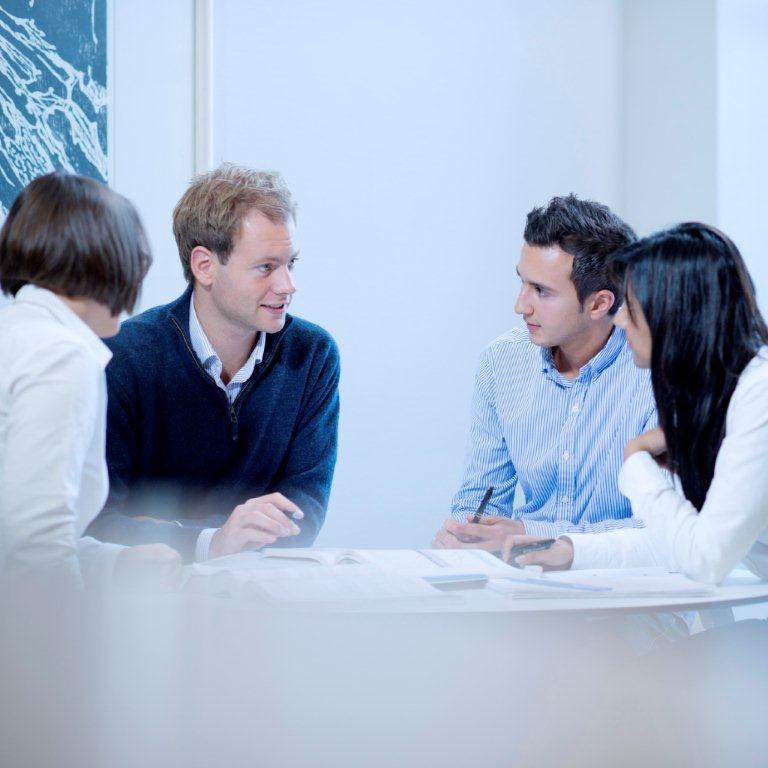 Study group discussing an academic text